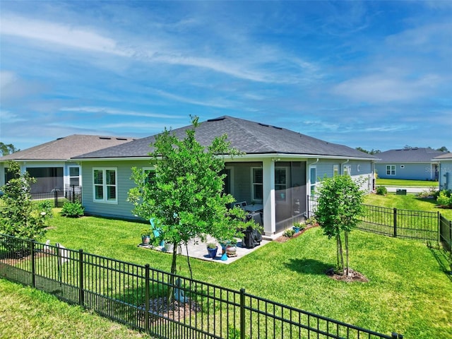 back of house with a lawn, a shingled roof, a patio, and a fenced backyard