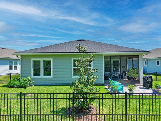 back of house with a yard, a patio area, roof with shingles, and a fenced backyard