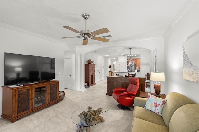 living area with arched walkways, visible vents, crown molding, and decorative columns