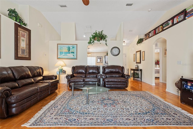 9 Pittman Dr, Palm Coast, FL 32164 - living area featuring arched walkways, wood finished floors, vaulted ceiling, and visible vents