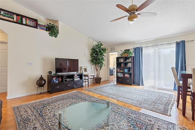 9 Pittman Dr, Palm Coast, FL 32164 - living area featuring ceiling fan, arched walkways, wood finished floors, and a textured ceiling