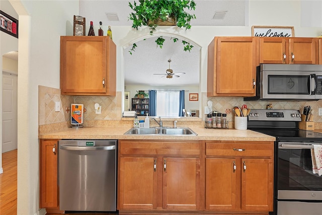 9 Pittman Dr, Palm Coast, FL 32164 - kitchen featuring a ceiling fan, light countertops, a sink, and appliances with stainless steel finishes