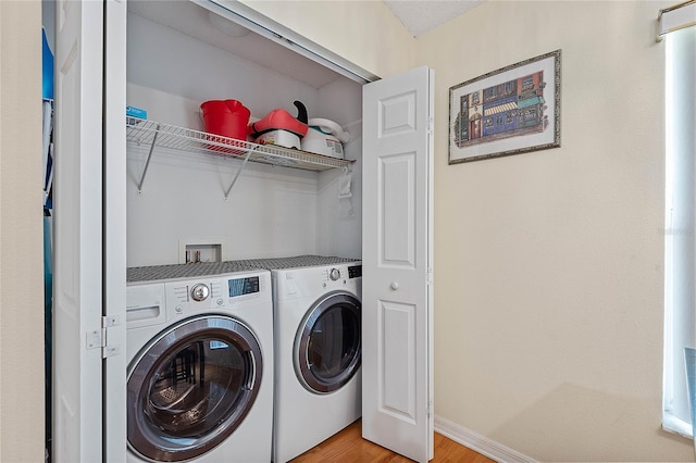 9 Pittman Dr, Palm Coast, FL 32164 - laundry room featuring baseboards, light wood-style flooring, washer and dryer, and laundry area