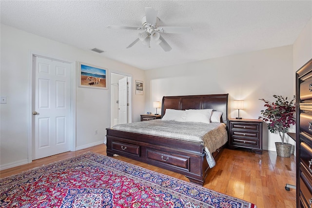 9 Pittman Dr, Palm Coast, FL 32164 - bedroom with a ceiling fan, light wood-style floors, visible vents, and a textured ceiling