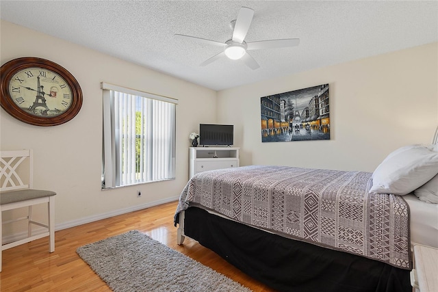 9 Pittman Dr, Palm Coast, FL 32164 - bedroom featuring baseboards, wood finished floors, a textured ceiling, and ceiling fan