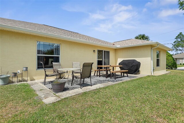 9 Pittman Dr, Palm Coast, FL 32164 - back of property featuring a lawn, roof with shingles, and a patio