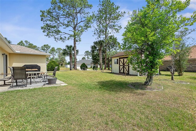9 Pittman Dr, Palm Coast, FL 32164 - view of yard with a patio area and an outbuilding