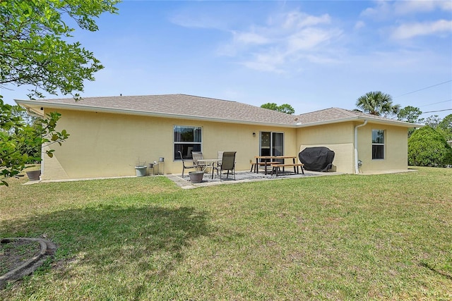 9 Pittman Dr, Palm Coast, FL 32164 - back of property with a lawn, a patio area, a shingled roof, and stucco siding
