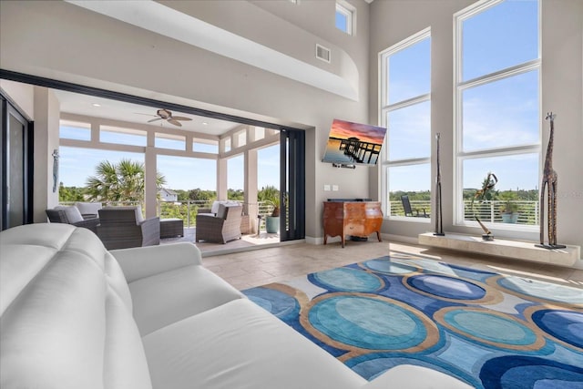 2590 Palm Ave, Flagler Beach, FL 32136 - tiled living area featuring ceiling fan and a towering ceiling