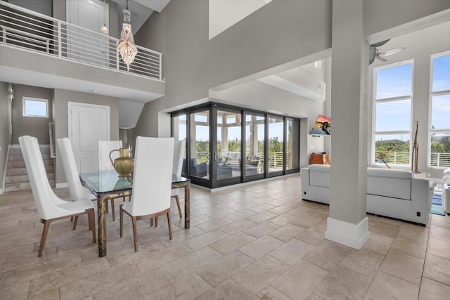 2590 Palm Ave, Flagler Beach, FL 32136 - dining room featuring a towering ceiling, healthy amount of natural light, and a ceiling fan