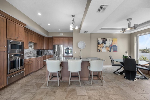 2590 Palm Ave, Flagler Beach, FL 32136 - kitchen featuring stainless steel appliances, a warming drawer, a kitchen bar, backsplash, and recessed lighting