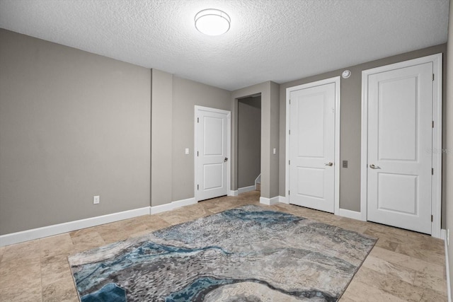 2590 Palm Ave, Flagler Beach, FL 32136 - bedroom with a textured ceiling and baseboards