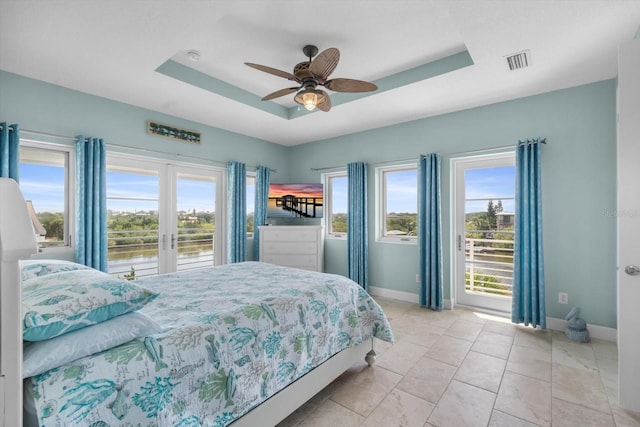 2590 Palm Ave, Flagler Beach, FL 32136 - bedroom with access to outside, a tray ceiling, a ceiling fan, and a water view
