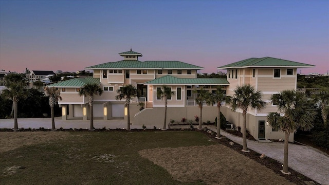2590 Palm Ave, Flagler Beach, FL 32136 - view of front of home featuring a metal roof and a yard
