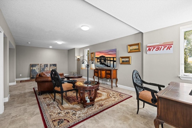 2590 Palm Ave, Flagler Beach, FL 32136 - living area with a textured ceiling and baseboards