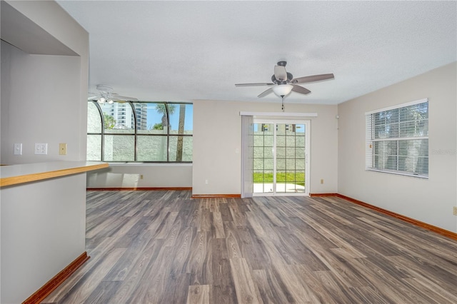 200 Florida Shores Blvd, Daytona Beach, FL 32118 - unfurnished room featuring baseboards, a ceiling fan, wood finished floors, and a textured ceiling