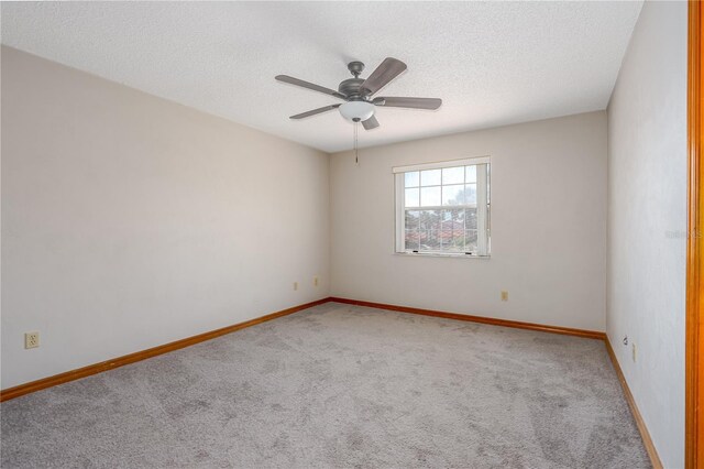 200 Florida Shores Blvd, Daytona Beach, FL 32118 - carpeted spare room with baseboards, a ceiling fan, and a textured ceiling