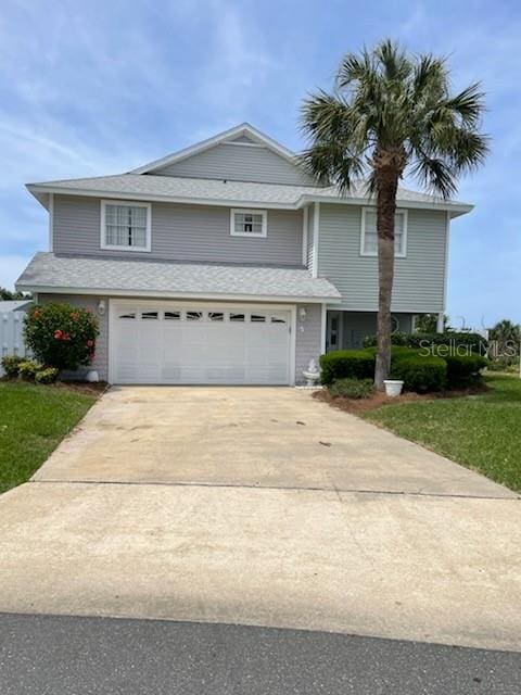 5 Nantucket Dr, Palm Coast, FL 32137 - view of front facade with an attached garage, a front lawn, and concrete driveway