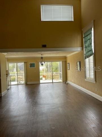 5 Nantucket Dr, Palm Coast, FL 32137 - unfurnished living room with baseboards and a high ceiling