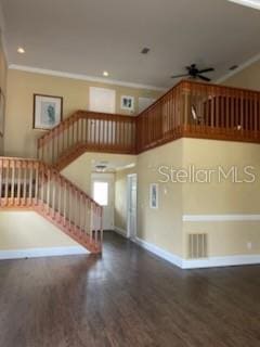 5 Nantucket Dr, Palm Coast, FL 32137 - unfurnished living room with baseboards, a ceiling fan, wood finished floors, stairway, and ornamental molding