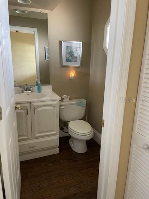 5 Nantucket Dr, Palm Coast, FL 32137 - bathroom featuring wood finished floors, vanity, and toilet