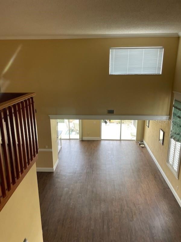 5 Nantucket Dr, Palm Coast, FL 32137 - empty room with baseboards, a healthy amount of sunlight, visible vents, and dark wood-style floors