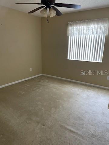 5 Nantucket Dr, Palm Coast, FL 32137 - carpeted spare room featuring baseboards and a ceiling fan