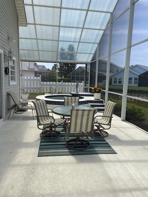 5 Nantucket Dr, Palm Coast, FL 32137 - view of patio featuring fence, a hot tub, and outdoor dining space