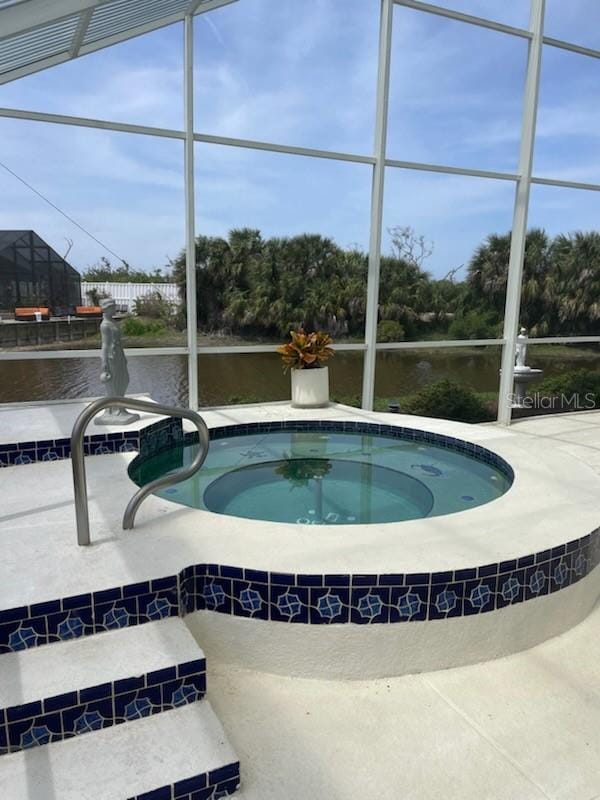 5 Nantucket Dr, Palm Coast, FL 32137 - view of swimming pool featuring a swimming pool, an indoor hot tub, a lanai, and a water view