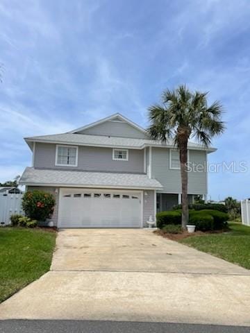 5 Nantucket Dr, Palm Coast, FL 32137 - view of front facade featuring concrete driveway, a front lawn, fence, and a garage