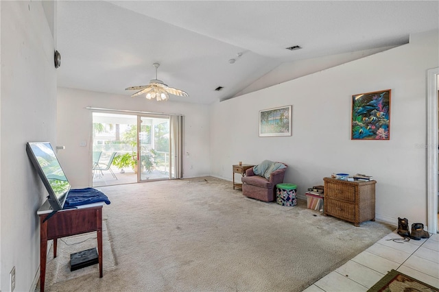 sitting room featuring tile patterned flooring, vaulted ceiling, visible vents, a ceiling fan, and carpet flooring