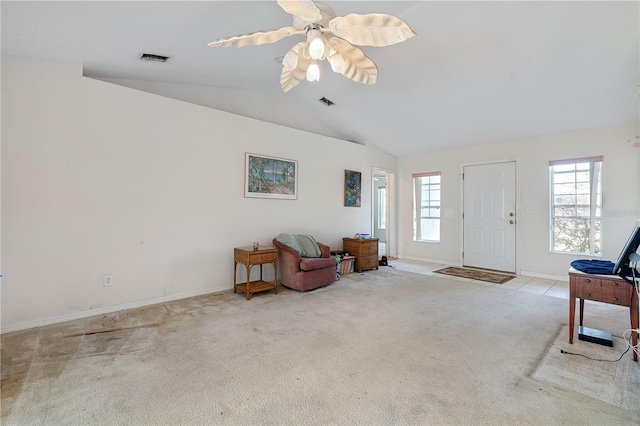 interior space with lofted ceiling, baseboards, carpet floors, and visible vents
