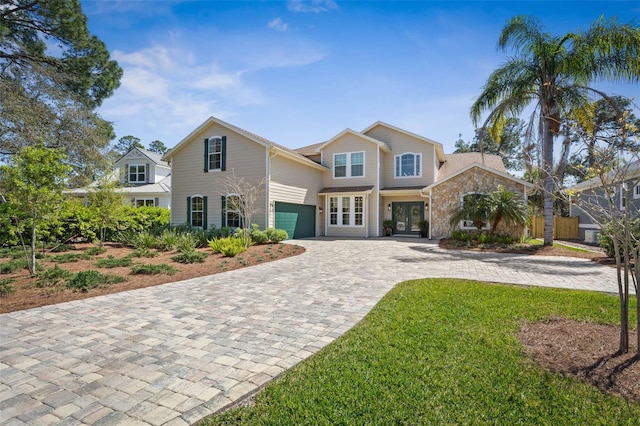 28 Cinnamon Grove Ln, Palm Coast, FL 32137 - view of front of home featuring a garage, decorative driveway, and french doors
