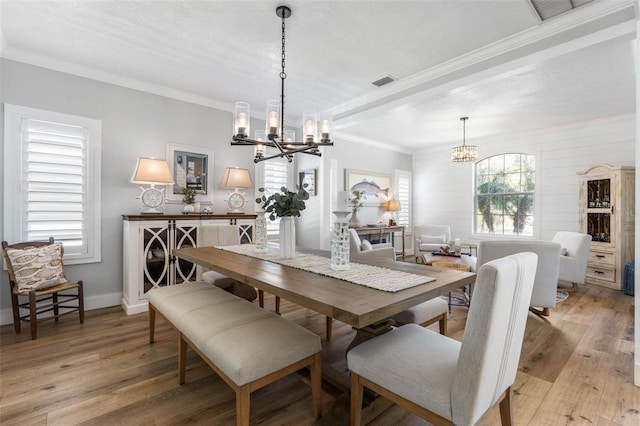 28 Cinnamon Grove Ln, Palm Coast, FL 32137 - dining area with visible vents, crown molding, a notable chandelier, and light wood-type flooring