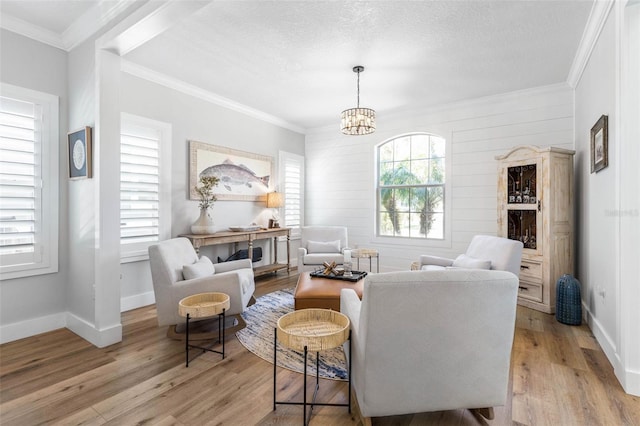 28 Cinnamon Grove Ln, Palm Coast, FL 32137 - living area with an inviting chandelier, baseboards, ornamental molding, and light wood-style flooring