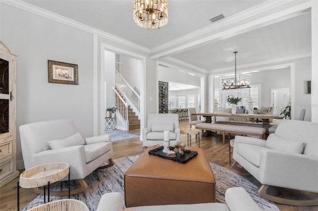 28 Cinnamon Grove Ln, Palm Coast, FL 32137 - living room featuring an inviting chandelier, crown molding, wood finished floors, and stairway