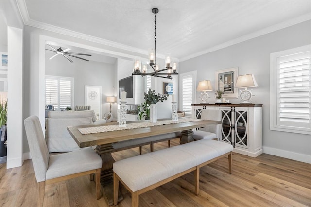 28 Cinnamon Grove Ln, Palm Coast, FL 32137 - dining room featuring crown molding, baseboards, ceiling fan with notable chandelier, and light wood-type flooring