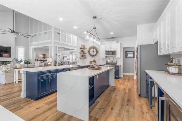 28 Cinnamon Grove Ln, Palm Coast, FL 32137 - kitchen featuring open shelves, stainless steel microwave, blue cabinetry, and white cabinetry