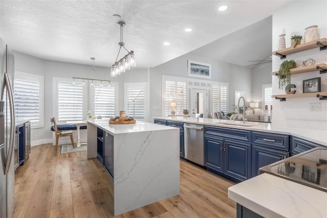 28 Cinnamon Grove Ln, Palm Coast, FL 32137 - kitchen featuring open shelves, a sink, a textured ceiling, blue cabinets, and appliances with stainless steel finishes