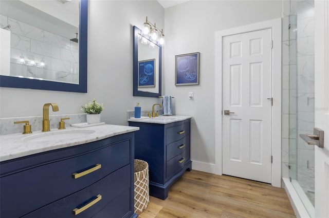 28 Cinnamon Grove Ln, Palm Coast, FL 32137 - full bath featuring wood finished floors, a sink, two vanities, and tiled shower