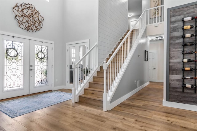 28 Cinnamon Grove Ln, Palm Coast, FL 32137 - entryway with french doors, stairs, a towering ceiling, and wood finished floors