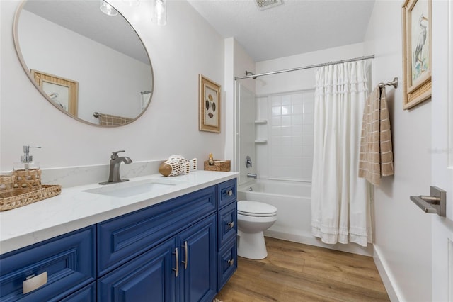 28 Cinnamon Grove Ln, Palm Coast, FL 32137 - full bathroom with vanity, wood finished floors, toilet, shower / bathtub combination with curtain, and a textured ceiling
