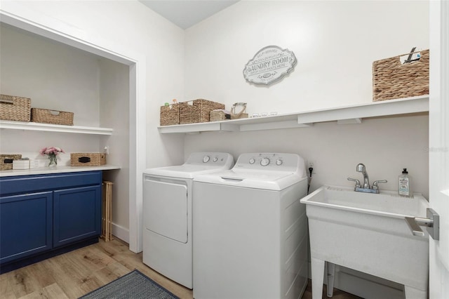 28 Cinnamon Grove Ln, Palm Coast, FL 32137 - laundry room with laundry area, a sink, light wood-style flooring, and separate washer and dryer