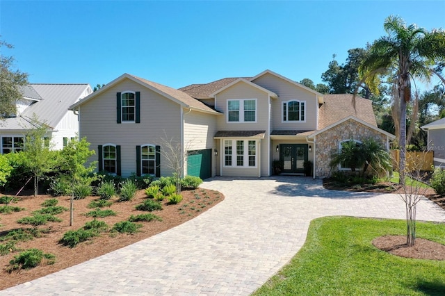 28 Cinnamon Grove Ln, Palm Coast, FL 32137 - view of front of property with a garage, decorative driveway, and french doors