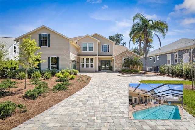 28 Cinnamon Grove Ln, Palm Coast, FL 32137 - back of property with glass enclosure, cooling unit, french doors, and an outdoor pool