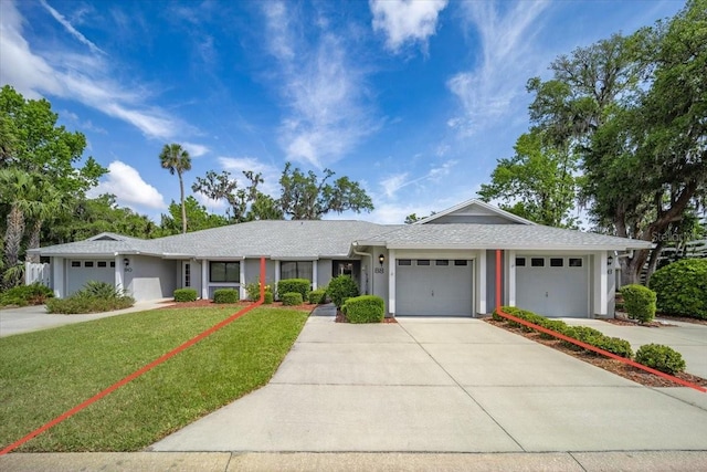ranch-style home with a garage, a front lawn, concrete driveway, and stucco siding