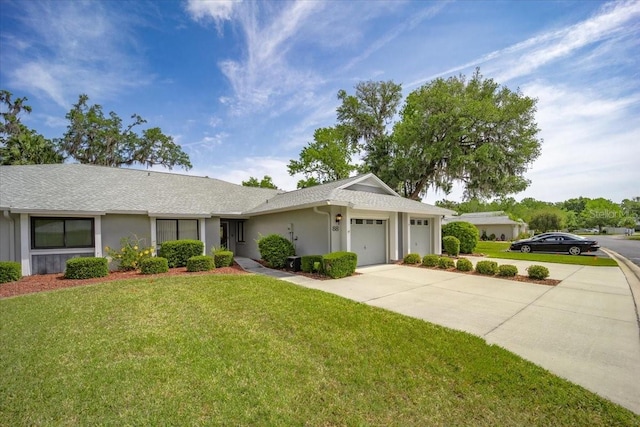 single story home with stucco siding, a front lawn, concrete driveway, and an attached garage