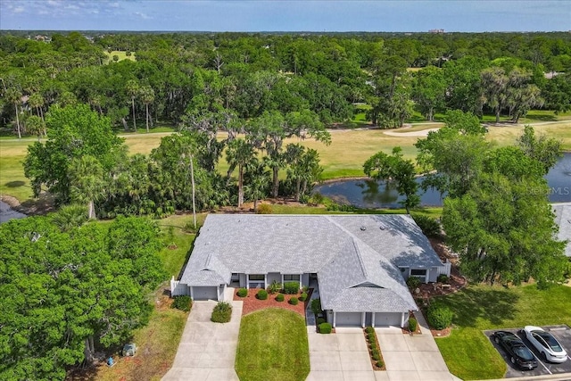 birds eye view of property with a forest view and a water view