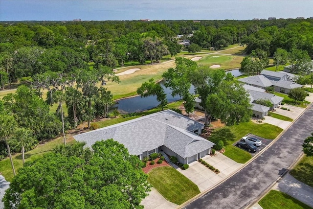birds eye view of property with golf course view, a water view, and a forest view