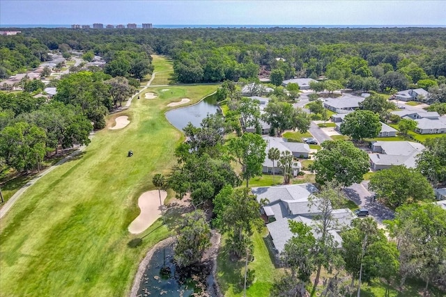 drone / aerial view featuring view of golf course, a water view, and a residential view